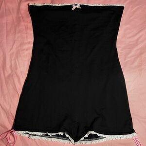 black jumpsuit w white lace trim and pink bows